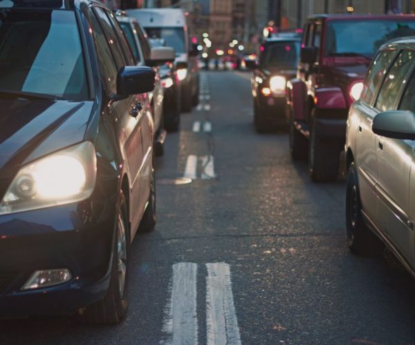 Picture of a cars on a dimly lit street - first priority insurance